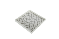 A white ivory serving tray with a geometric pattern.