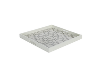 A white ivory serving tray with a geometric pattern.