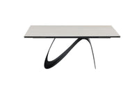 A contemporary extendable dining table with a white marble top and black base, shown in a fully extended state.