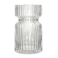 Clear glass vase with wavy design on a white background