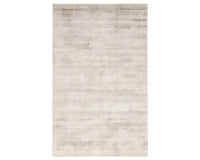 A light taupe area rug with a solid pattern, handwoven from 100% viscose.