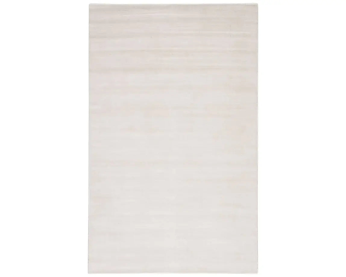 A white, solid color area rug on a plain background.