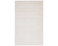 A white, solid color area rug on a plain background.