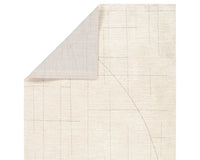 A beige area rug with a geometric pattern.