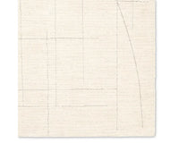 A beige area rug with a geometric pattern.