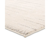 A rectangular beige area rug with a simple geometric pattern and power loomed construction.