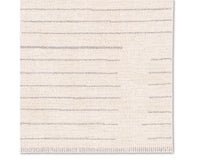 A rectangular beige area rug with a simple geometric pattern and power loomed construction.