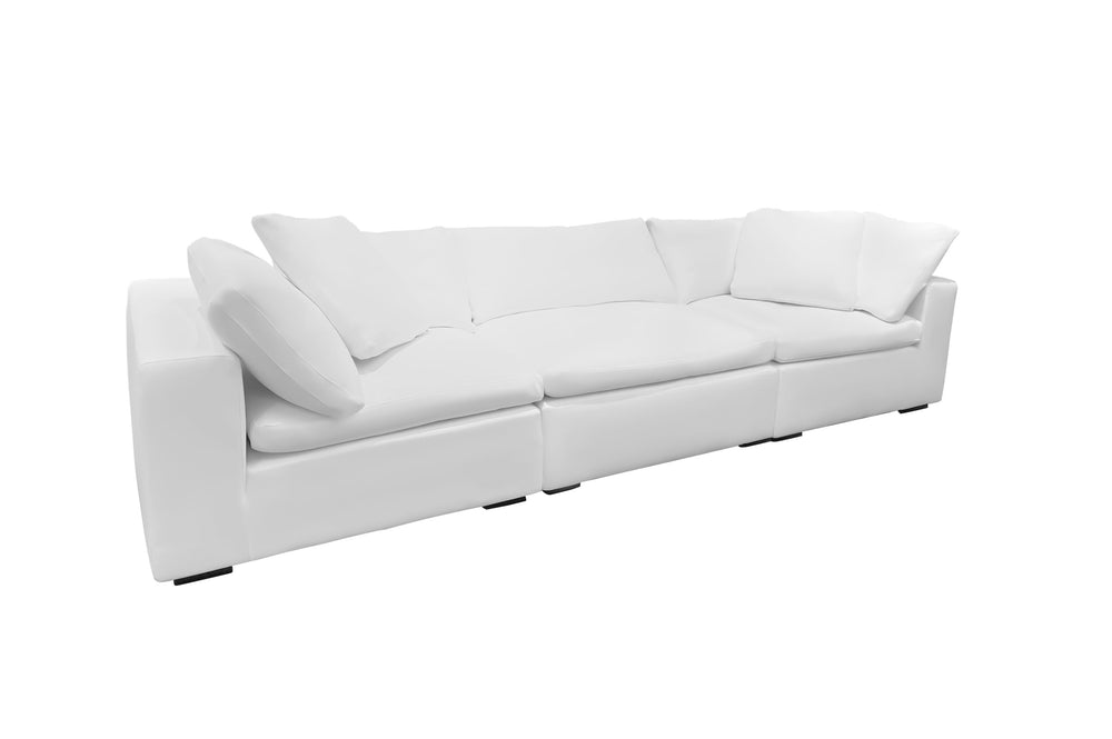 A white, modular Kara sectional sofa with deep cushions and wooden legs.